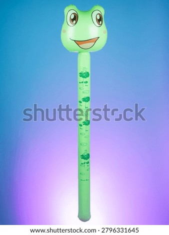 Close-up of an inflatable stick with frog-shaped inflatables on a purple background, highlighting its playful and fun design.