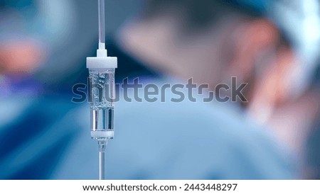 Close-up of the infusion process. A drop of saline is dropped for intravenous infusion.