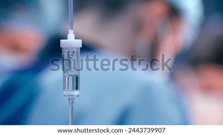 Close-up of the infusion process. A drop of saline is dropped for intravenous infusion.