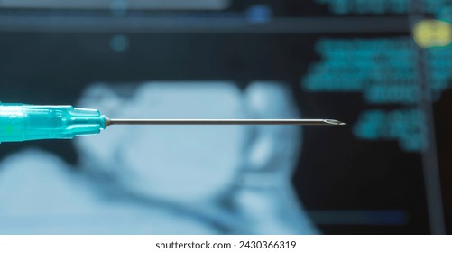 Close-up of injection needle with x-ray film in the background. Medical expert, doctor, hospital operating room. - Powered by Shutterstock