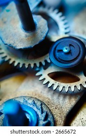 Closeup of the inner workings of a clock. Focus on the gear teeth.