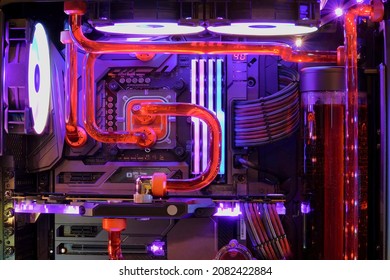 Close-up And Inside High Performance Desktop PC And Water Cooling System On CPU Socket With Multicolored LED RGB Neon Light Show Status On Working, Interior On Computer PC Case And DIY