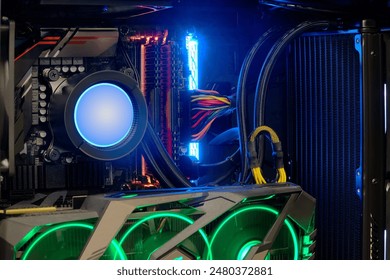 Close-up inside Hi-performance custom computer desktop with liquid pump that installed on socket CPU processor and radiator for cooling and LED neon light show status on working