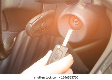 Closeup Inside Vehicle Of Hand Holding Key In Ignition, Start Engine Key.