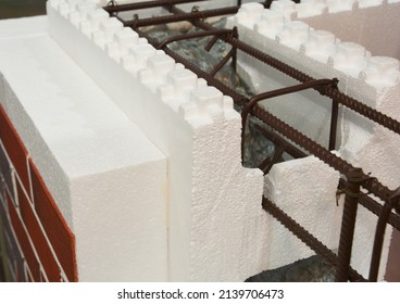 A close-up of an insulated concrete form (ICF) wall with an expanded polystyrene insulation, steel reinforcement filled with concrete as a modern energy efficient building technology.  - Shutterstock ID 2139706473