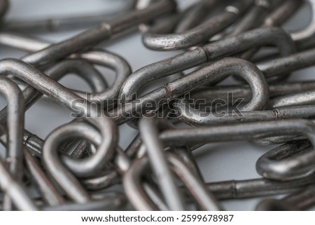 Close-up of interlinked metal chains, showcasing their strong, durable structure. Ideal for industrial, security, or construction themes.







