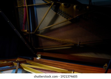 A close-up of the internal string structure of a top grand piano
