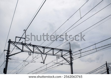 Close-up of the intricate network of electrical cables above the railroad tracks.