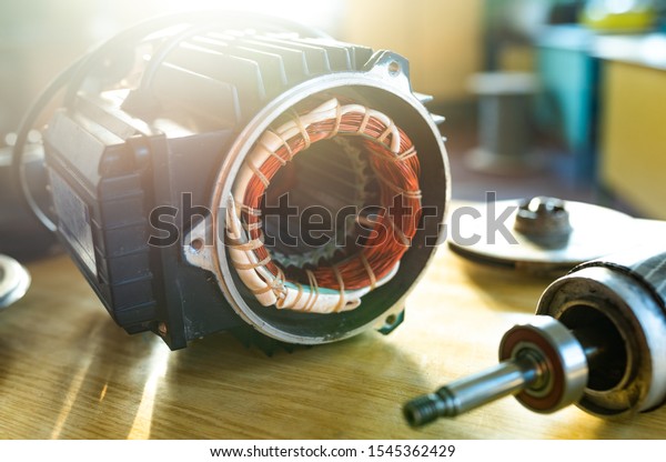 Close-up of an iron industrial\
motor lies on a table during the production of new modern trucks in\
a factory. The concept of reliable and high-quality special\
cars