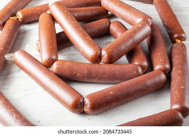 Closeup Isolated Image Of Strings Of Homemade Sucuk Or Sausage Stuffed In Casing And Made Into Strings Before Drying. Processed Red Meat Consumption Concept.