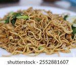 Closeup of Japanese famous foods in white plate.Solaria,Stir-fried noodles with chicken and vegetables.