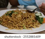 Closeup of Japanese famous foods in white plate.Solaria,Stir-fried noodles with chicken and vegetables.