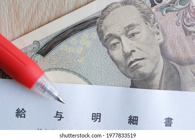 A Close-up Of Japanese Pay Slips. Translation: Pay Stub.