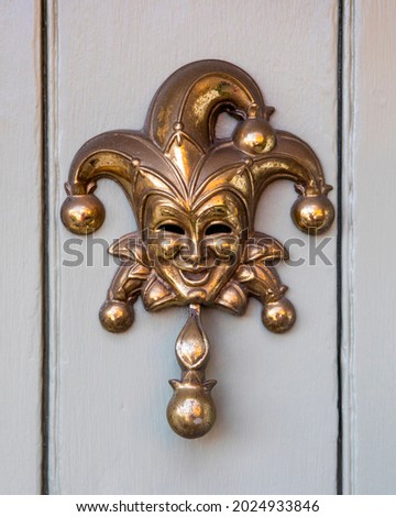 Close-up of a Jester door knocker.