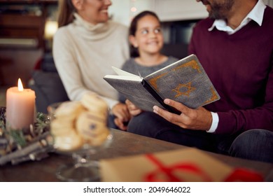 Close-up Of Jewish Family Reading Tanakh  While Celebrating Hanukkah At Home.