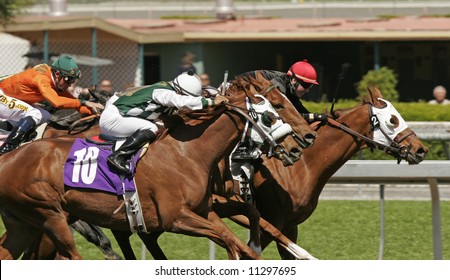 Close-Up Of Jockeys Racing To The Finish Line In A Thoroughbred Horse Race