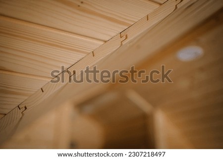 Close-up of the joint of the ceiling and wall boards of the igloo sauna