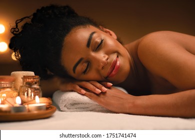 Closeup Of Joyful Black Lady Sleeping At Spa Salon Next To Aromatherapy Plate, Spa Concept