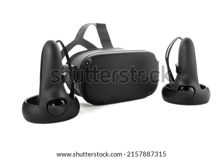 Close-up of Joysticks and VR glasses isolated on white background. Virtual reality kit. Two controllers and a VR helmet. Front side view