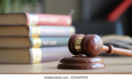 Close-up Of Judge Gavel On Wooden Sounding Block And Pile Of Law Books. Jurisprudence, Attorney, Justice And Law Concept