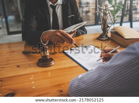 Close-up of a judge with a hammer against the background of professional lawyer talking about a lawsuit. professional lawyers discussing legal case.