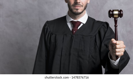 Close-up Judge In Robe Holding Gavel