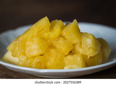 Close-up Of Juicy Yellow Pineapple Flesh In A White Plate. Spot Focus