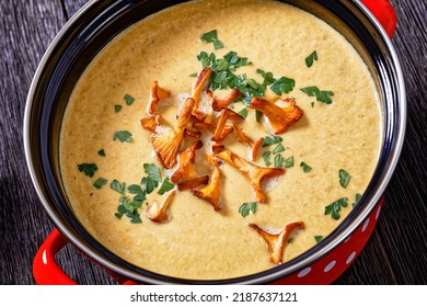 Close-up Of Kanttarellikeitto, Finnish Chanterelle Soup In Red Pot On Dark Wooden Table, Horizontal View From Above