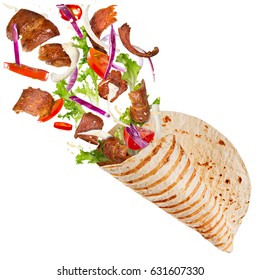 Close-up of kebab sandwich with flying ingredients. Freeze motion.