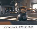 Closeup of kettlebell weight on gym floor.