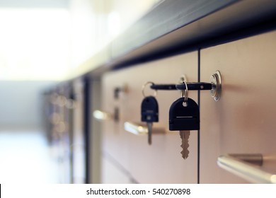 Close-up Key Locked On Filing Cabinet Drawer Desk Furniture In Office Building.