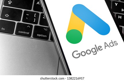 closeup keyboard laptop and Google AdWords app icon on smartphone screen. Google is the biggest Internet search engine in the world. Moscow, Russia - April 27, 2019