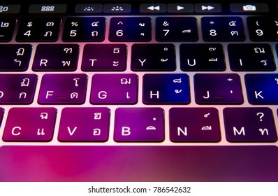 closeup keyboard touchbar colorful light with thai english Language , laptop , notebook