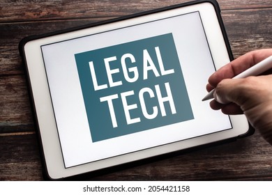 Closeup keyword Legal Tech (Legal technology) on tablet. Technology and software to provide legal services and support in the legal industry concept. Man hand holding wireless stylus pen