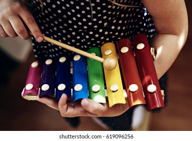 Close-up Of Kid Playing On Xylophone. Child Development Concept. 