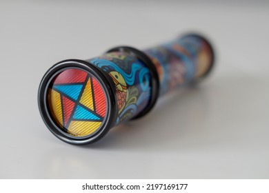 Close-up Of A Kid's Kaleidoscope Toy Used To Create Abstract Images While Looking Through The Viewfinder. Selective Focus.