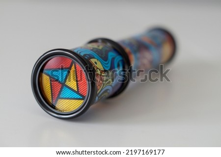 Close-up of a kid's kaleidoscope toy used to create abstract images while looking through the viewfinder. Selective focus.