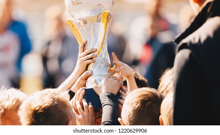 Close-up of Kids Sports Team with Trophy. Boys Celebrating Sports Achievement. Team Sports Champions. Soccer Football Winning Victory Celebration Moment - Powered by Shutterstock