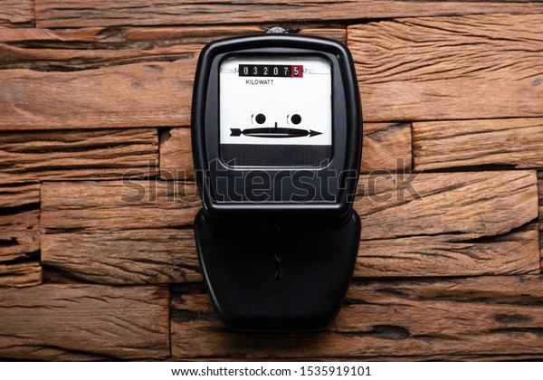 Close-up\
Of A Kilowatt Electricity Meter On Wooden\
Desk