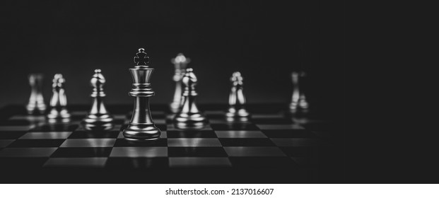 Close-up king chess standing first on chess board concepts challenge or battle fighting of business team and leadership strategy and organization risk management or team player.