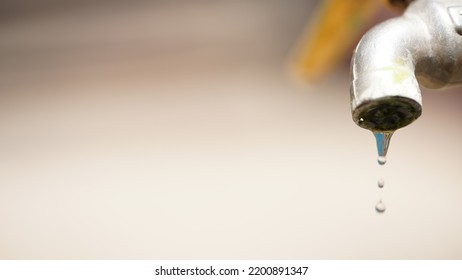 Close-up Kitchen Faucet, Dripping Tap Water That Doesn't Close Properly, Causing Wasted Water.