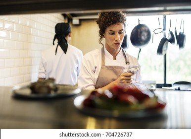 Closeup Of Kitchen Staff Prepare Cooking Ingredients