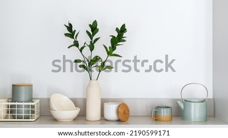 Closeup of kitchenware and decor on surface in kitchen. Home comfort. Organizational space in kitchen. Set of utensils. Contemporary flat for sale