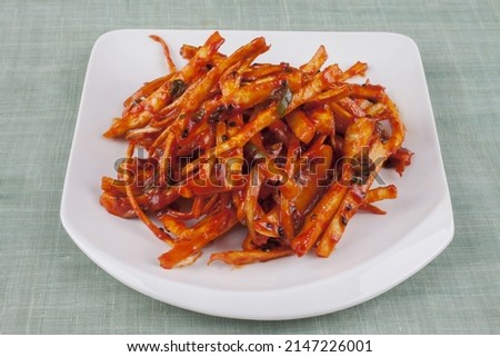 Close-up of Korean Food Seasoned Bellflower Roots with hot pepper paste on white plate, South Korea
