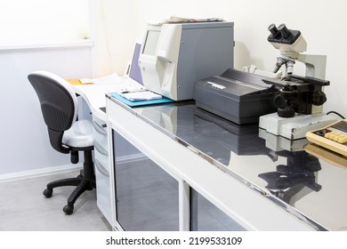 Close-up Of A Laboratory Room With Microscope, Test Tubes, Centrifuge Machine And Printer.