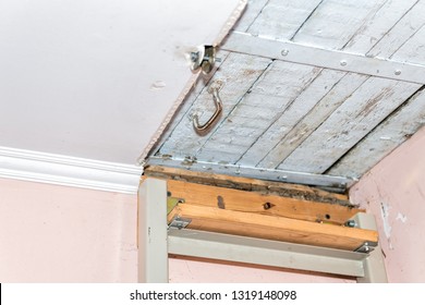 Closeup Of Ladder Leading To Closed Door Latch To Attic With Wooden Ceiling In Retro Vintage Dacha Cottage Home In Country Countryside