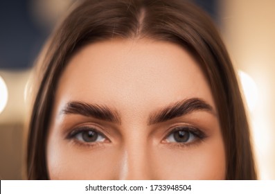 Close-up Of Laminated And Stained Eyebrows. Eyebrow Care Trend. Laminating And Extension For Lashes. Beauty Model With Long Eyelashes And Brows.