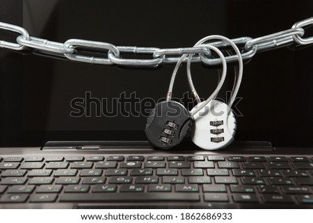 Closeup of laptop with chains and locks. Information security concept.