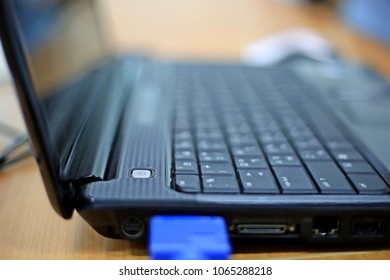 A close-up of a laptop computer placed on a table in a meeting room selective focus and shallow depth of field