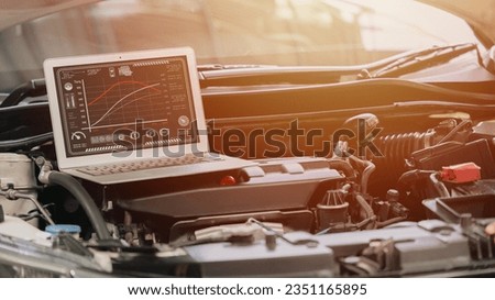 closeup laptop computer with racing car engine ecu speed tuning with modern software display torque and horsepower on screen
